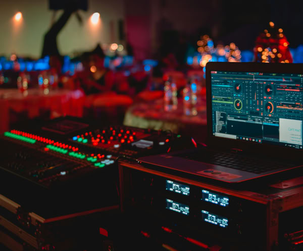 Black Laptop Beside Audio Mixer Set